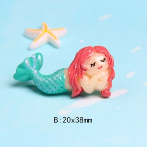 Detailed view of red-haired resin mermaid charm measuring 20x38mm for DIY crafts