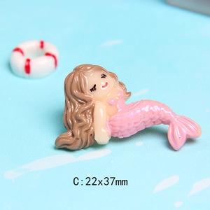 Macro view of a 22x37mm resin mermaid figurine with pink glitter tail for DIY crafts