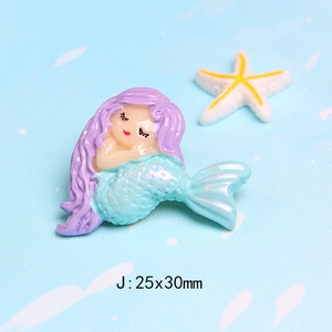 Macro detail of a 25x30mm resin mermaid charm for DIY crafts and hair accessories