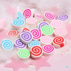 Macro shot of colorful spiral marshmallows on white feathers for DIY slime and phone cases