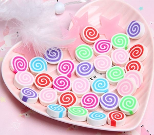 Macro shot of colorful spiral clay marshmallows in a heart tray for DIY crafts and decor