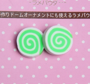 Detailed view of green and white spiral pattern resin charms for DIY craft projects