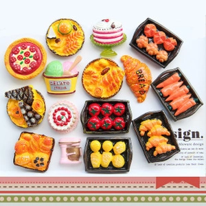 Close-up of miniature food fridge magnets including gelato, bread and fruit baskets