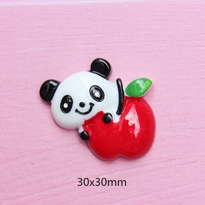 Macro view of 30x30mm resin panda hugging apple DIY accessory for phone cases