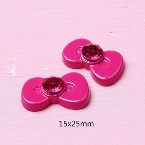 Detailweergave van 15x25mm hars cartoon strik accessoires met roze stras