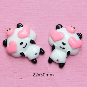 Close-up of 22x30mm resin panda charms with pink hearts for DIY phone case making