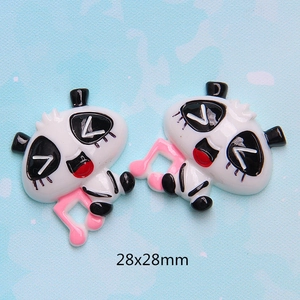 Detailed macro view of 28x28mm panda resin charms with pink music note for DIY crafts