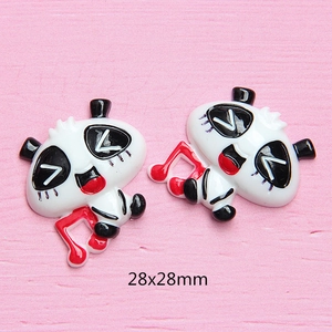 Macro detail of 28x28mm panda resin charm with musical notes for DIY phone case crafts