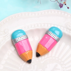 Colorful resin pencil charms for DIY crafts and stationery decoration on white plate