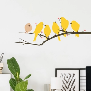 Close-up of yellow birds on tree branch wall stickers in a minimalist living room
