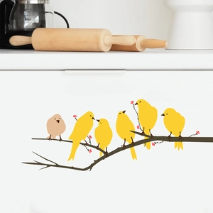 Detail of bird on branch wall decals applied to a white kitchen cabinet surface