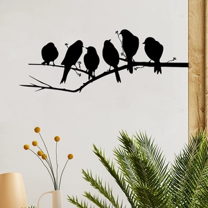 Detail of bird silhouette on branch wall decal in a minimalist white living room