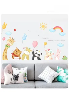 Detail of cartoon animal wall stickers featuring giraffe and cat in a living room setup