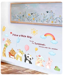 Detail of cartoon animal wall stickers with giraffe, panda and sun in a child room setting