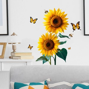 Detailed view of sunflower and butterfly wall decals on a clean white indoor wall