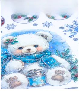 Detail of a Christmas decal showing a teddy bear with silver glitter snowflakes and holly