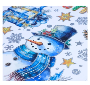 Detail of silver glitter Christmas wall stickers featuring snowmen and blue gift boxes