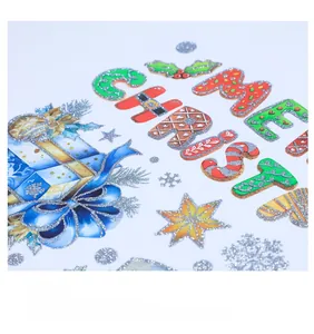 Close-up of glittery Christmas stickers with colorful letters and snowflake details