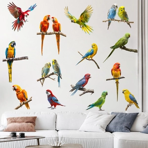 Vibrant parrot wall decals applied to a white wall above a sofa in a modern living room