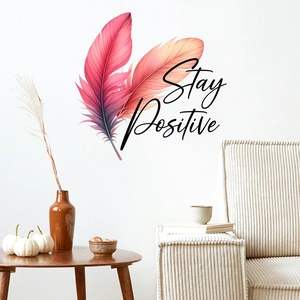 Detail of gradient feather wall decal with Stay Positive text in a minimalist room