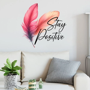 Detail of colorful feather wall decals with 'Stay Positive' quote in a modern living room