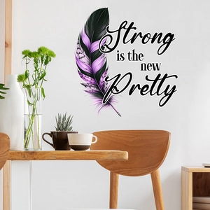 Detail of waterproof feather wall decal with Strong is the new Pretty quote on white wall