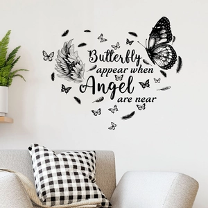 Black butterfly and angel wing heart wall decal with artistic text on white wall