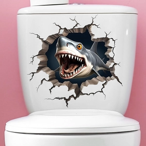 Detail showing a 3D shark wall sticker with a cracked wall effect on a white toilet tank