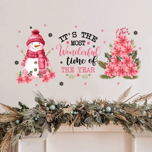 Detail of pink snowman wall stickers and festive greeting on a living room wall
