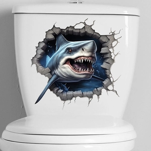 Close-up of 3D cracked wall shark sticker applied on a white ceramic toilet tank