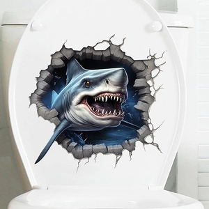 Macro shot of 3D shark wall sticker with realistic broken wall effect on white toilet