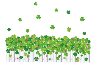 Détail du sticker mural trèfle vert avec clôture blanche et petites fleurs roses