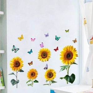 Detail of vibrant sunflower and butterfly wall decals on a clean white interior wall