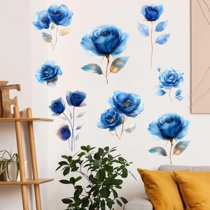 Macro detail of blue rose wall stickers with gold leaf accents on a white interior wall