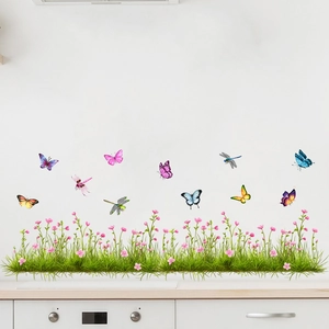 Detail of self-adhesive wall stickers with green grass, flowers and colorful butterflies