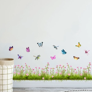 Detail view of colorful butterfly and dragonfly wall stickers on a clean white wall surface