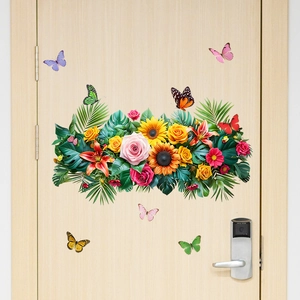 Detail of sunflower and butterfly wall stickers applied on a light wood bedroom door