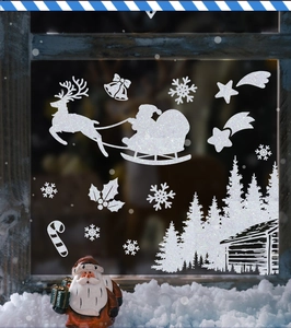Detalle de pegatinas navideñas blancas con Papá Noel, renos y copos de nieve para ventanas