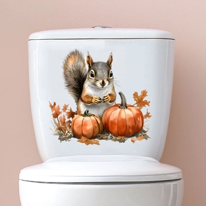Detail view of squirrel and pumpkin autumn wall stickers applied on white ceramic surface