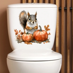 Detail of squirrel pumpkin wall sticker on white toilet tank with autumn maple leaf accents