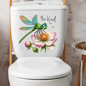 Detail of 3D dragonfly and lotus wall sticker with Be Kind text on white surface