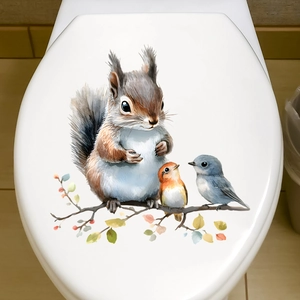 Watercolour squirrel and birds decal on a white toilet lid for bathroom decoration