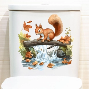 Waterproof adhesive wall sticker showing a cute squirrel and autumn leaves on a toilet tank