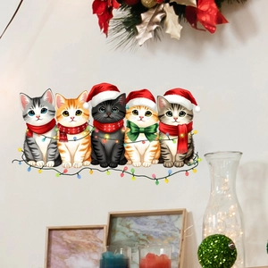 Detail of Christmas cat wall stickers with festive scarfs and hats on a white wall