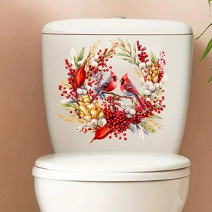 Detail view of bird and red berry wreath sticker applied on a white toilet tank surface
