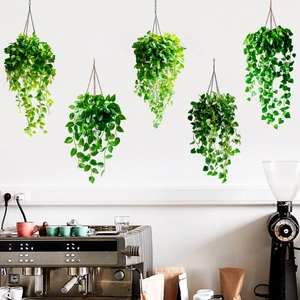 Hanging artificial green vines on white wall above coffee bar area wall decor