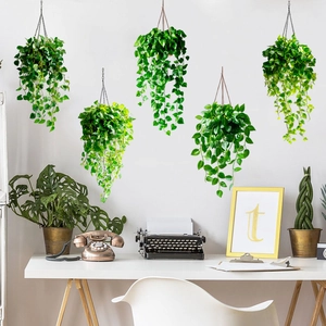 Detail of hanging green plant wall stickers showing realistic ivy leaves in a home setting