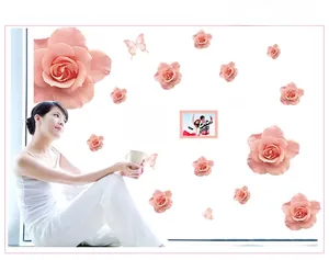Detailed view of pink rose wall stickers with butterflies and photo frames for bedroom decor