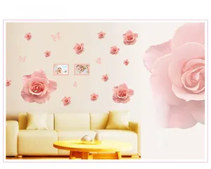 Detail view of pink rose wall stickers and butterfly decals on a living room sofa wall
