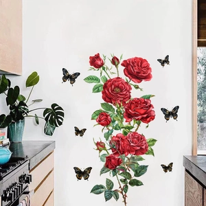 Detail showing red rose and butterfly wall stickers on a modern kitchen wall surface